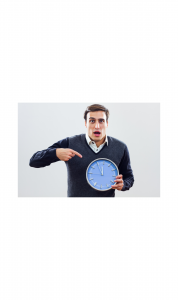 man holding clock and pointing to it