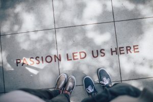 feet next to the ground which reads "passion led us here" to reinforce the idea that service and volunteering in substance abuse recovery is a healthy habit