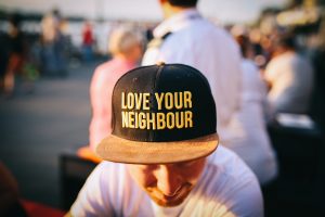 a picture of a man in a baseball cap that says "love your neighbor" which reinforces the idea of guiding principles in recovery from substance abuse